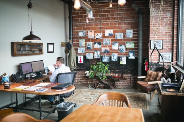 Man with community photos in office